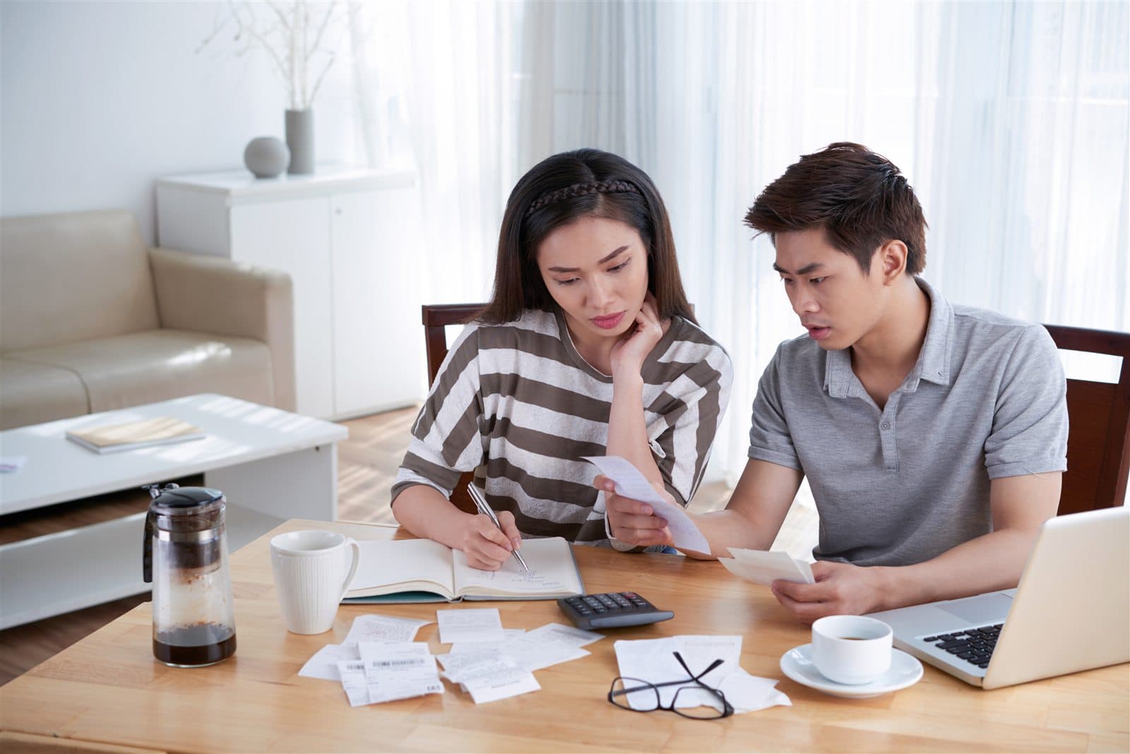 A couple planning their property budget at home